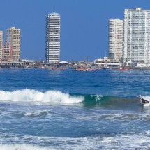 Peninsula de Cavancha of Iquique with two girls on their surfboard